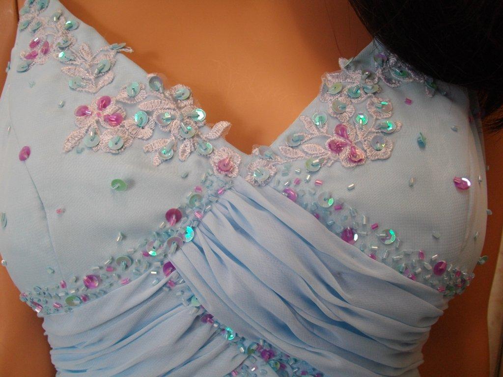Bodice and pleated waistline is accented with light purple and blue sequins and beading