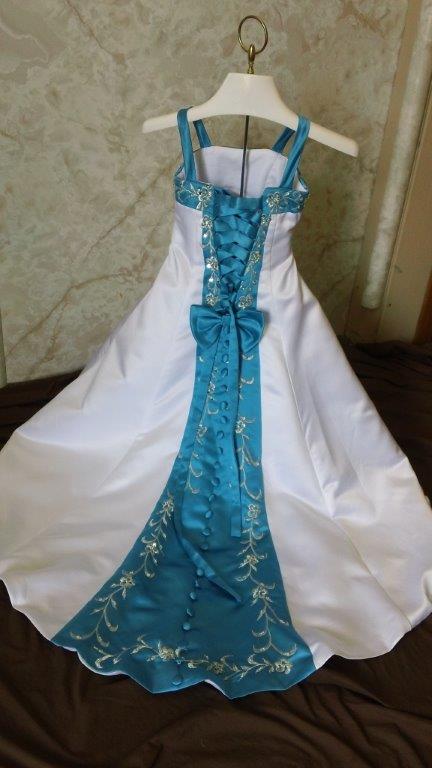 white and turquoise wedding gown with matching infant dress