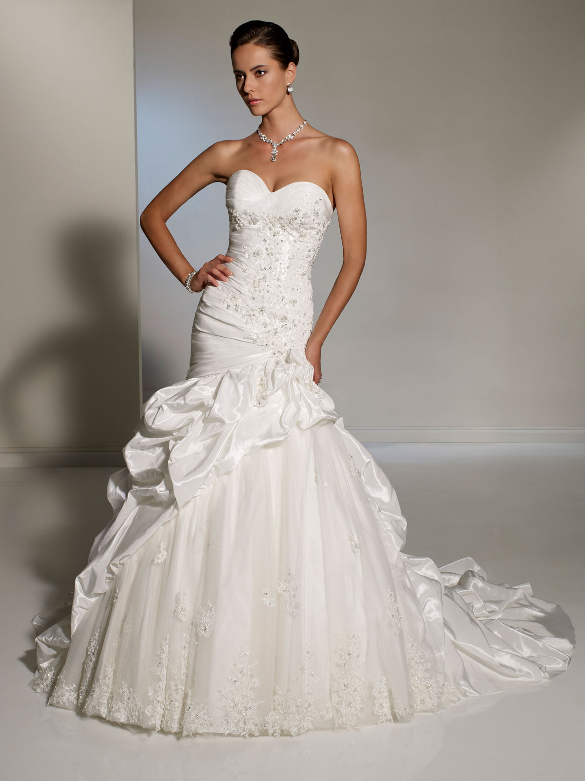 Fitted wedding dresses with pick up skirt and cascading pick up train
