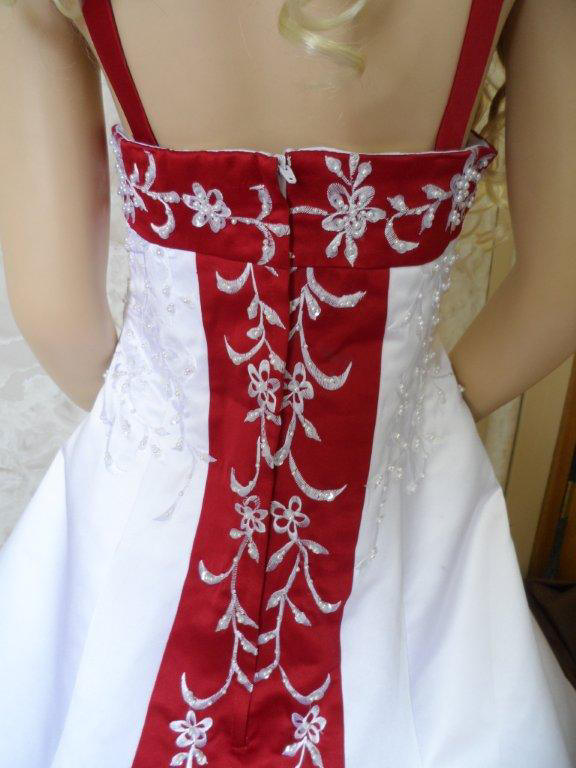 white embroidered on red train of miniature wedding gown
