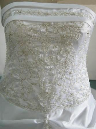 White strapless Bodice is banded with beaded embroidery