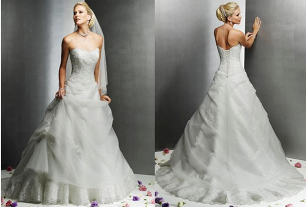 Sheer applique and lace enhance this strapless wedding gown