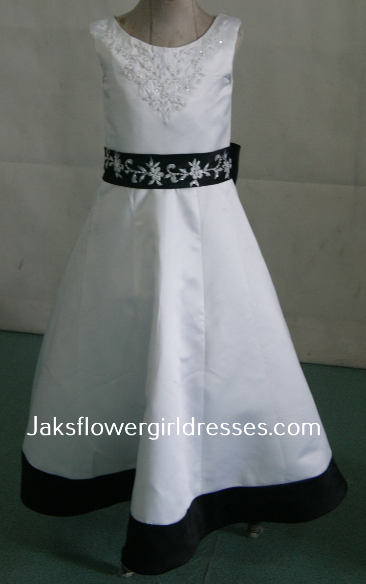 white sleeveless dress with black waistband and hem