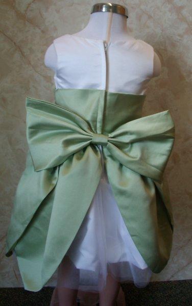 white and sage green toddler dress with large bow in the back