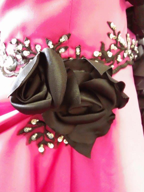 pink gown with black rose accents