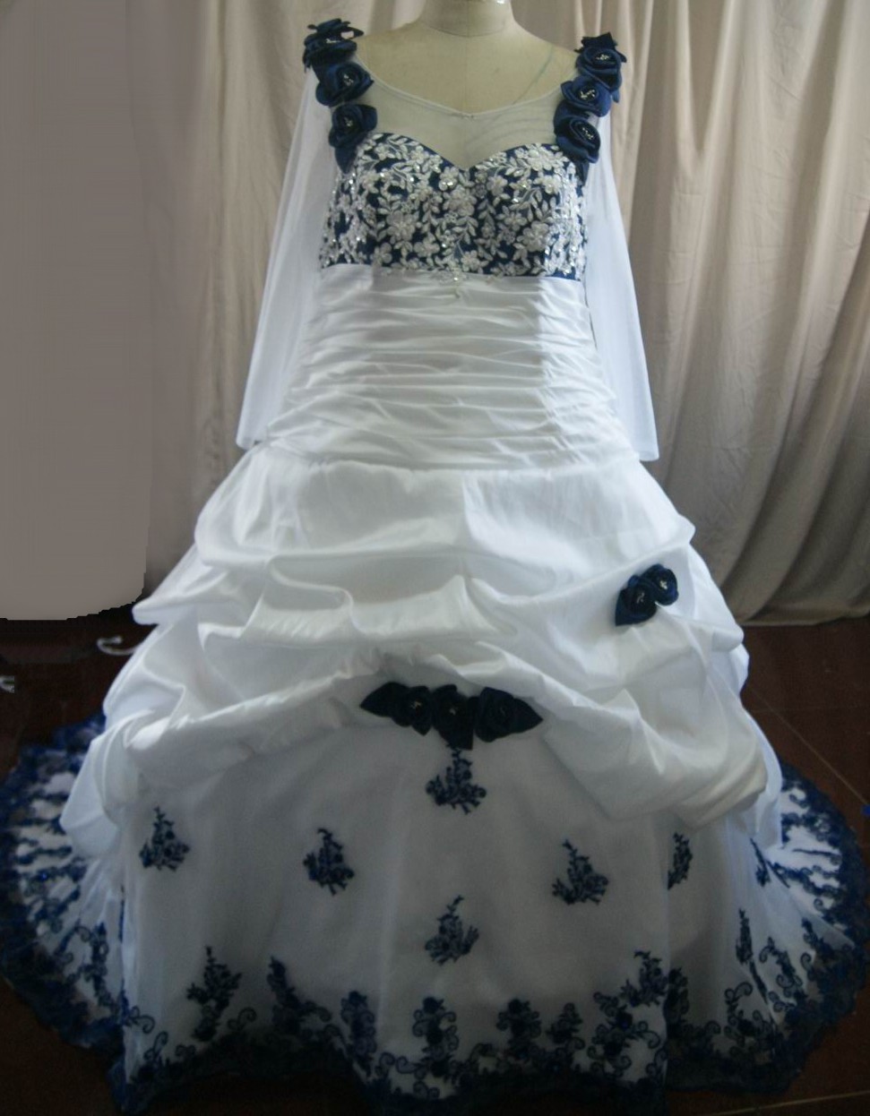 white wedding gown with royal blue roses