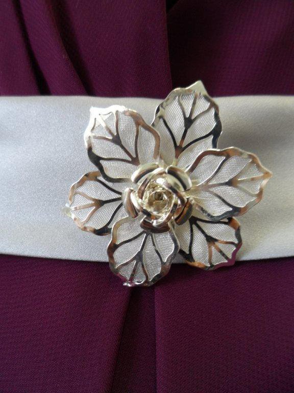 Waistline is adorned with a broach