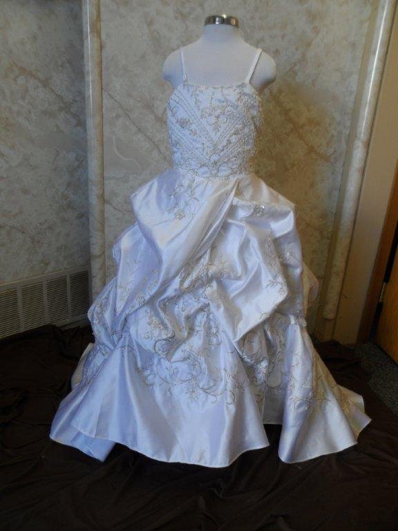 features embroidery to complement the bodice, skirt and train