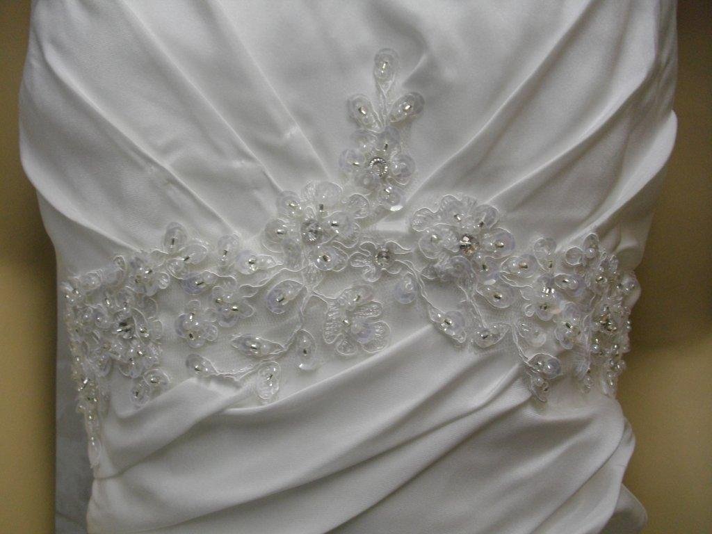 lace applique enriches the pleated empire bodice