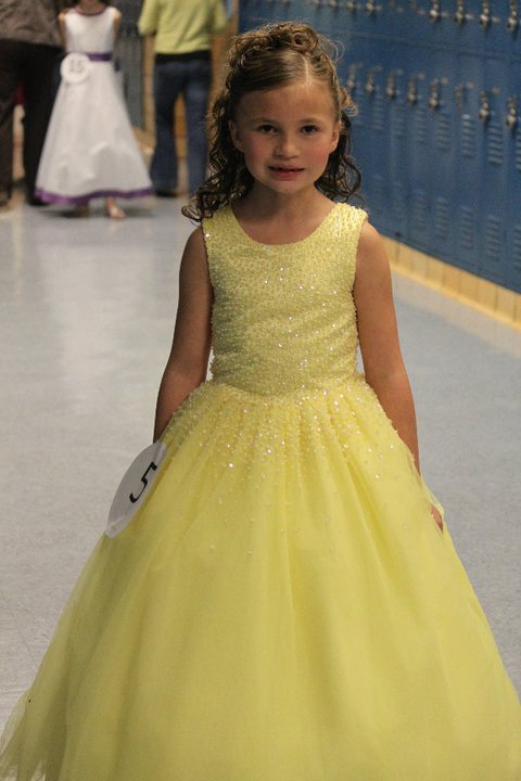 Yellow long sleeveless beaded pageant gown