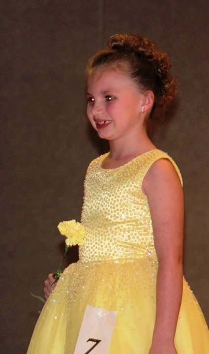 Yellow long sleeveless beaded pageant gown