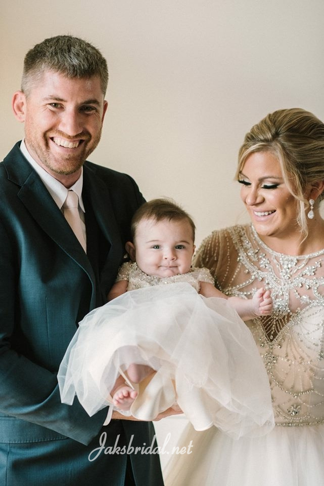 bride and groom with baby daughter