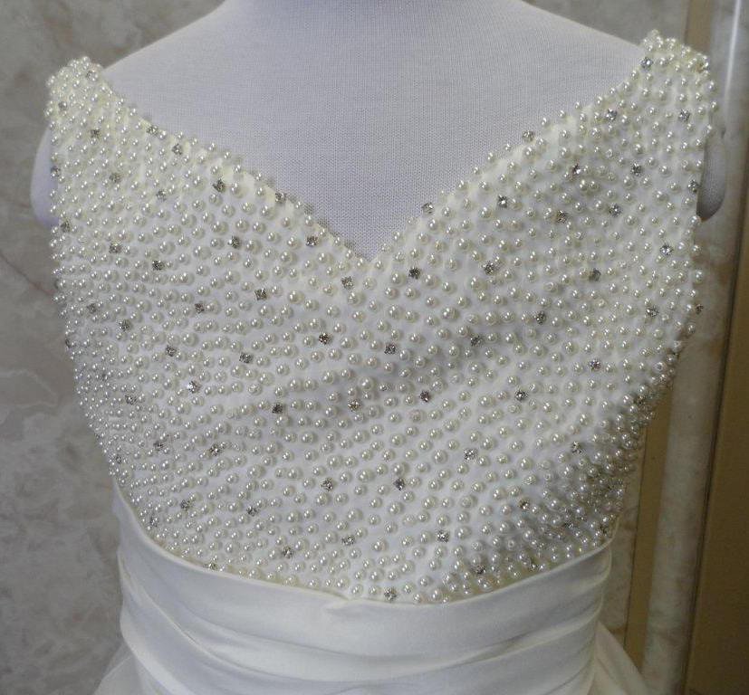Faux pearls and rhinestones enrich this flower girl dress
