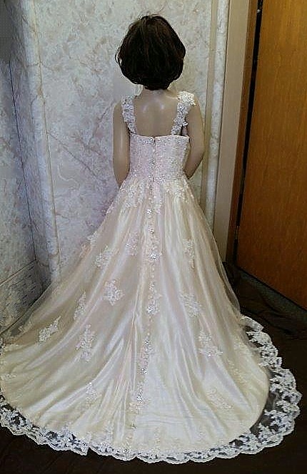 Champagne lace flower girl dress with sweetheart neck and long beautiful train.