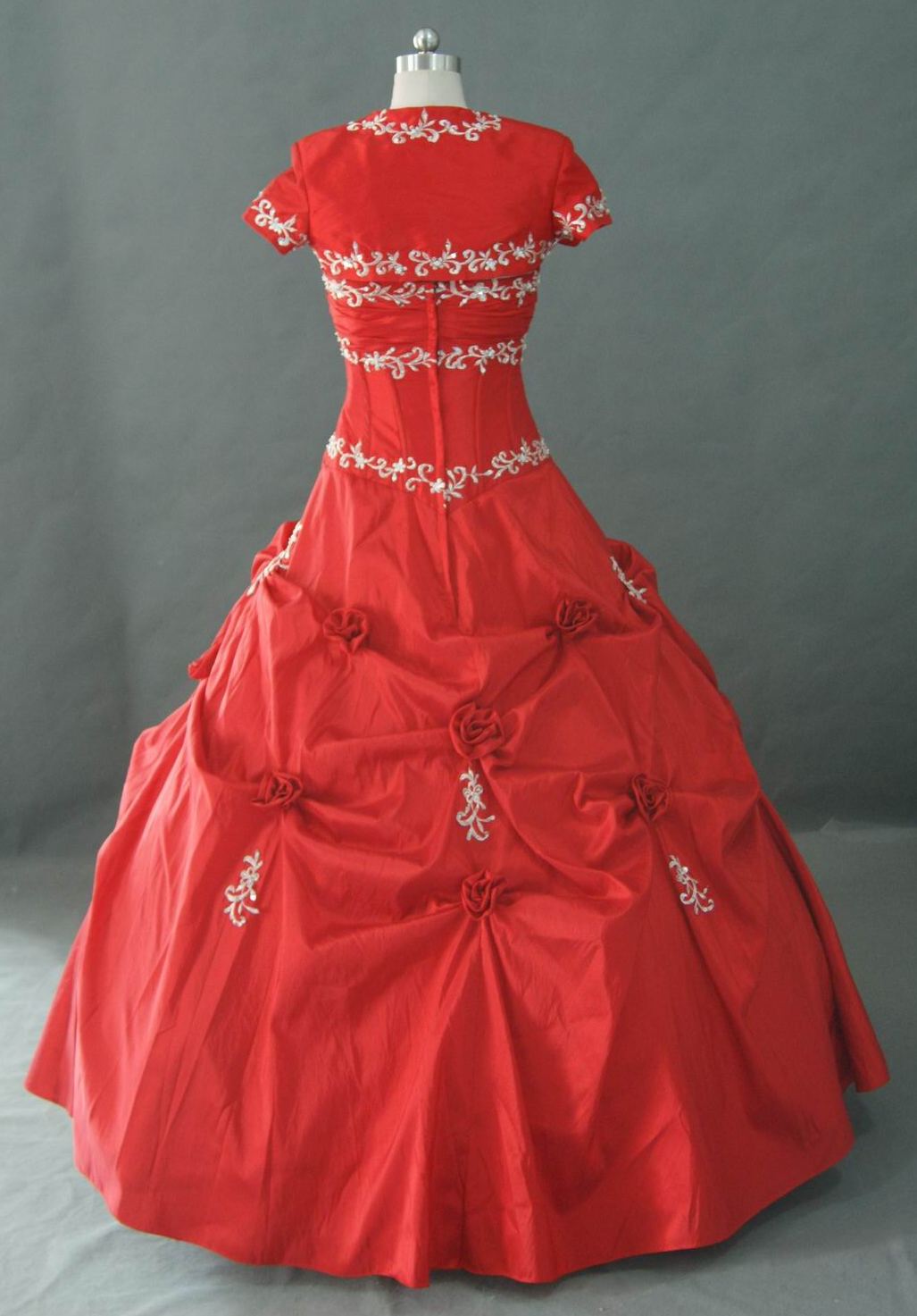 Red drop waist prom dress with flower detail.